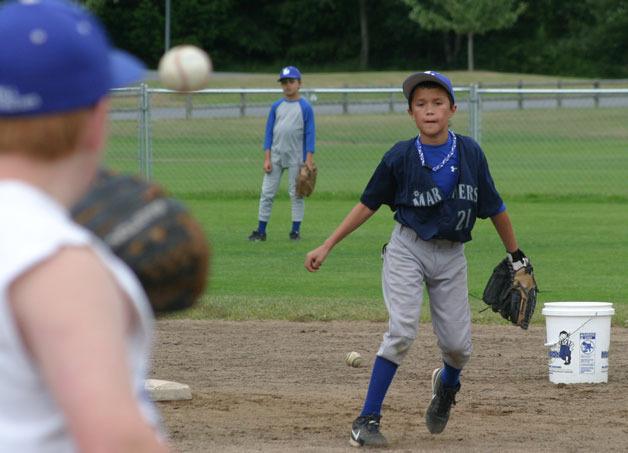 Alex Black tosses to Casey Justus at first base during practice for the South Whidbey Little League 11/12 All-Stars.