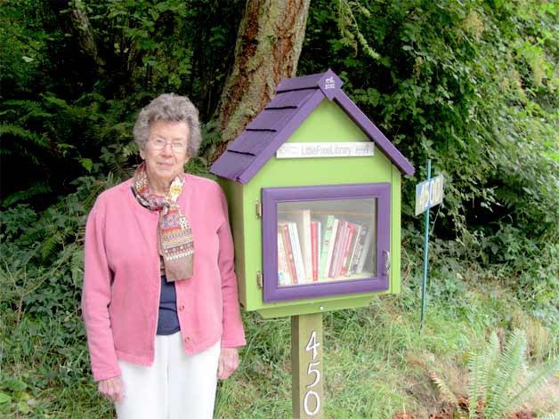Mildred Erickson stands beside her Little Library