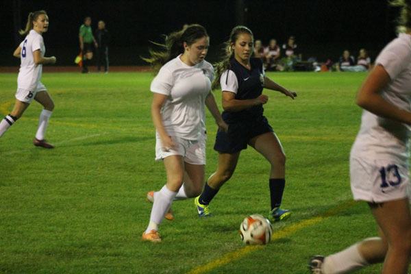 Senior Falcon defender Annie Lux dribbles the ball with an Ealges defender contending. South Whidbey tied Cedar Park Christian