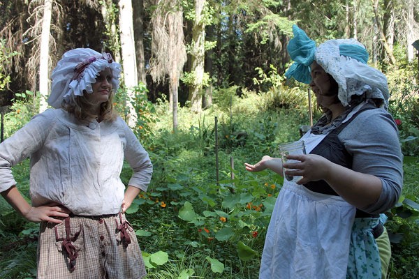 Allegra Rose Brown (left) and Julie Kuhfahl (right) chat near their cabin in the woods