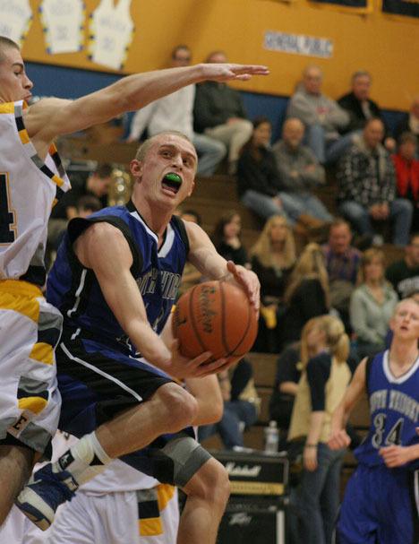 South Whidbey’s Sam Lee tries to loop a shot around Greg Nelson of Burlington-Edison during the Falcons’ first district playoff game.