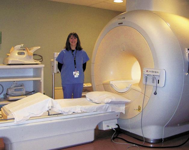 Ann Merriman stands with the MRI at Whidbey General Hospital.