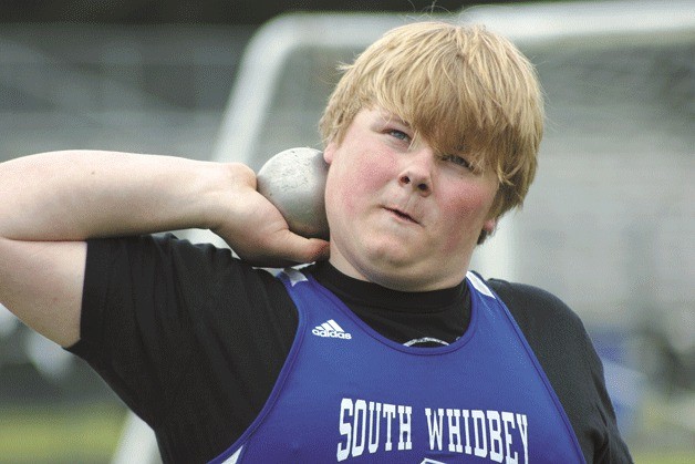 South Whidbey’s Colton Justus competes in the shot put against Coupeville in Langley on Thursday.  He placed second with a throw of 35 feet
