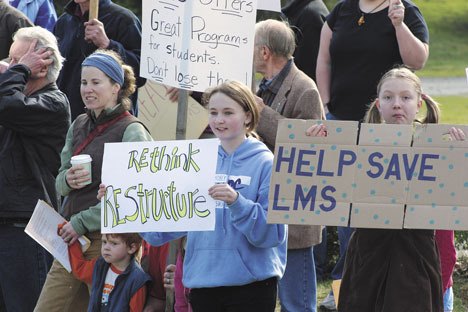 Sixth-graders Maddie Barker and Sanna Bjork protest the closing of Langley Middle School this past weekend on Camano Avenue in Langley.