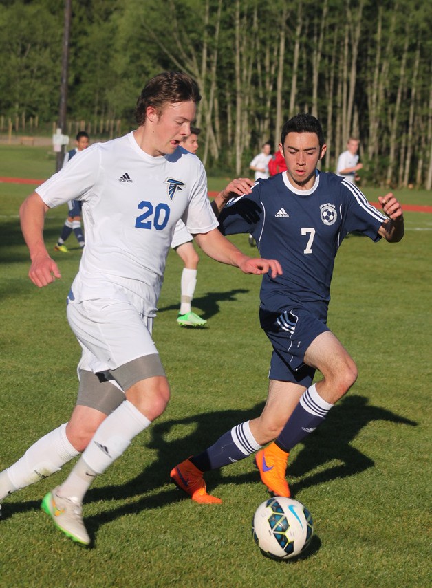 Andy Zisette dribbles down the sideline with Sultan sophomore defender Josh Morehead keeping pace. The Falcon senior continued a three-game scoring streak with a pair of goals in the 1A District 1 playoff match.