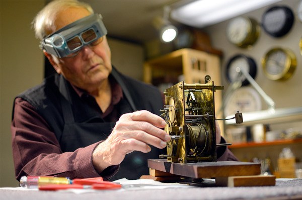 Herb Helsel works on an antique clock in his shop