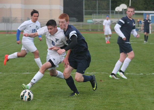 Falcon junior midfielder Lucas Leiberman fights for position against a Cedar Park Christian player March 24 at South Whidbey High School.