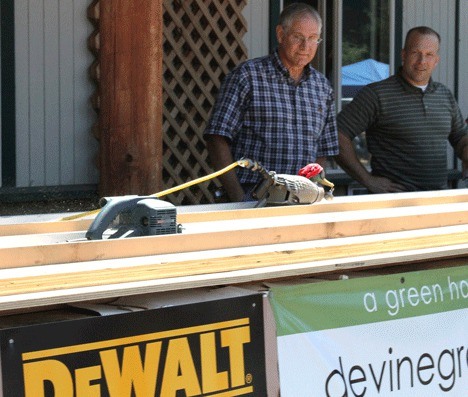 Ken Green of Oak Harbor watches his belt sander