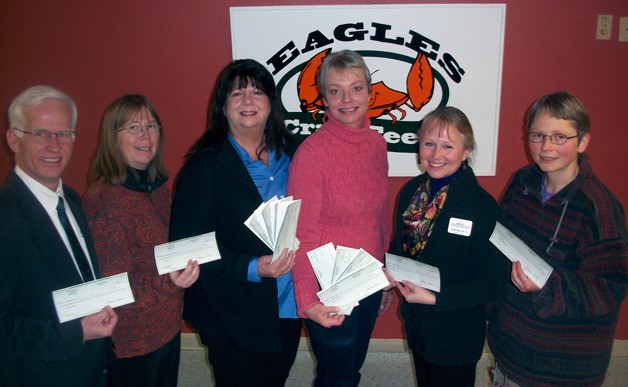 The Eagles had plenty of checks to hand out to community organizations Thursday. From the left are Kevin Lungren