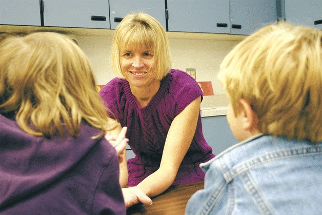Valerie Brown works on math skills with first-grade students Sophia Kinata and Kai Gallagher. Brown and the other teachers in South Whidbey School District will soon be subject to evaluations funded by a state grant.