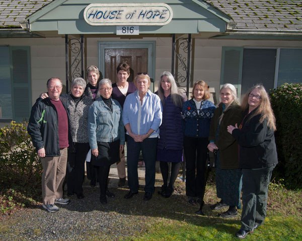 South Whidbey Homeless Coalition members stand in front of the House of Hope in Langley in 2015. The organization is holding a fundraiser Saturday