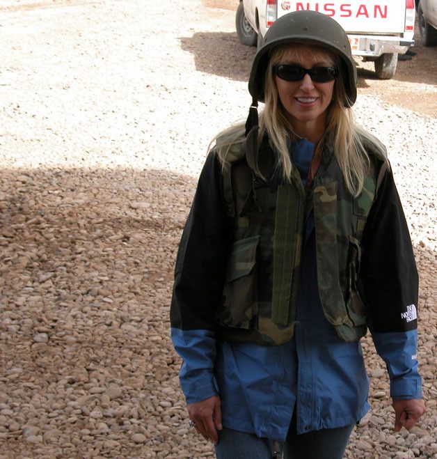 Comedian Jennifer Rawlings in a flak jacket and helmet  during a USO tour.