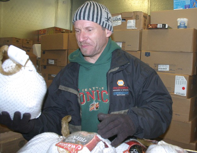 Jesse Kinskie unloads turkeys at the Good Cheer Food Bank. Kinskie and another volunteer