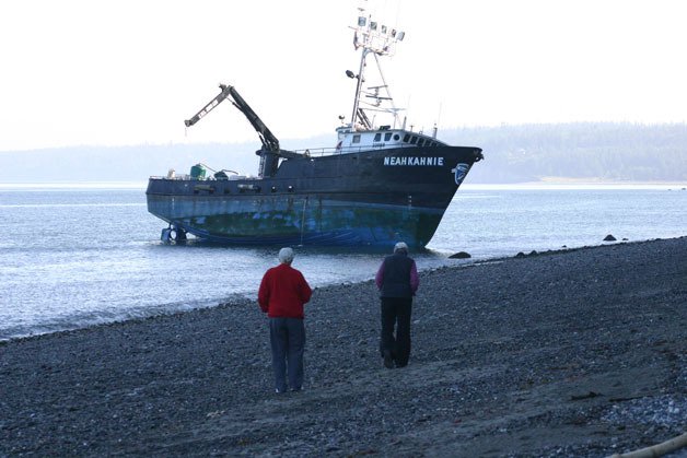 Lagoon Point residents watch the Neahkahnie which went aground early Tuesday morning. Plans are to pull the boat free with tugboat that will arrive at 3 p.m.