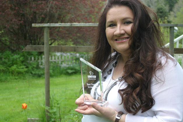 Suzanne Kelman holds up her “Best Feature Screenplay” award which she received from the Los Angeles United Film Festival for her script “Maggie the Brave.” The script is currently being financed for development by MovieHatch.com.