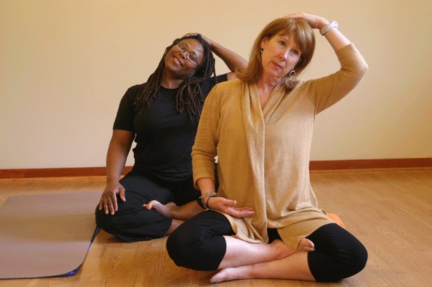 Victoria Santos and Valerie Easton strike a yoga pose at their brand-new Half Moon Yoga Studio in Langley Village.