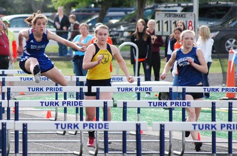 South Whidbey’s Laura Barrow is on her way to third place and a berth at state as she clears a hurdle Friday in the 100-meter event at Sultan during the District 1 track-and-field meet.