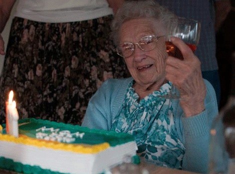 Martha Bergmann hoists a celebratory glass of wine during a party for her 102nd birthday in March.