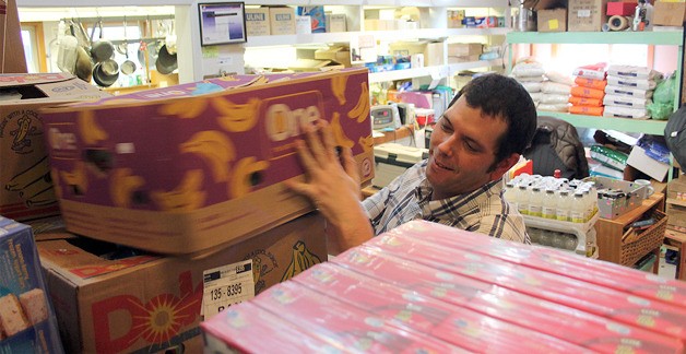 Scott Stark stocks the shelves at the Good Cheer Food Bank the week before Thanksgiving Day.