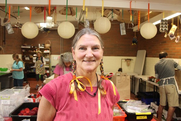 Mary Fisher visits the Whidbey Island Nourishes team as they prepare dozens of lunches for children and families on the island. She helped found the organization that works to feed people in need across Whidbey Island.