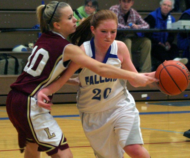 South Whidbey junior Madi Boyd drives around Lakewood sophomore Hailey Senyitko on Tuesday.
