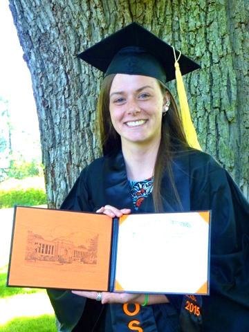 Emily Martin presents her diploma and cover from Oregon State University