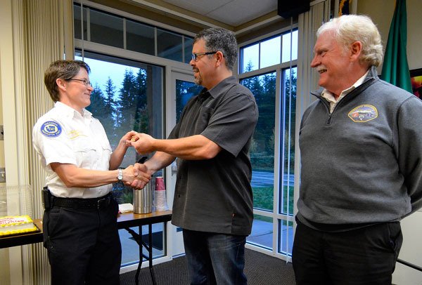 South Whidbey Fire/EMS Deputy Chief Wendy Moffatt receives her new badge from district Commissioner Kenon Simmons during a business meeting Thursday.