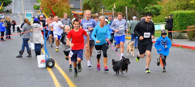Thirteen-year-old Langley resident Alex Low (red shirt) and Julie Buktenica (blue shirt) with her dog