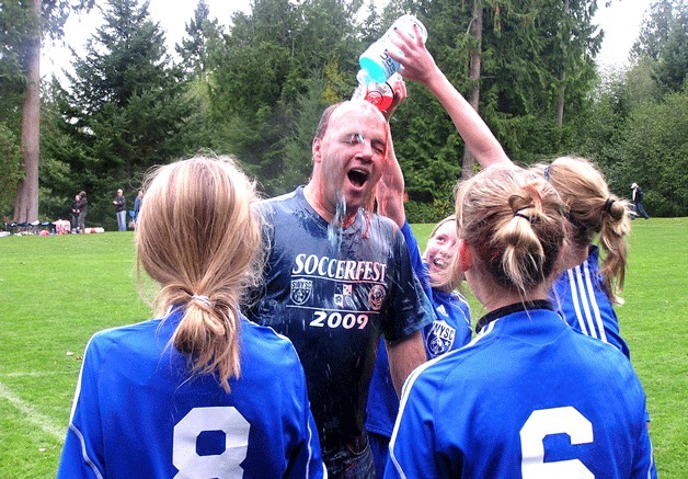 Islanders U-12 girls soccer head coach Cliff Bjork gets a Gatorade shower after winning the division title.
