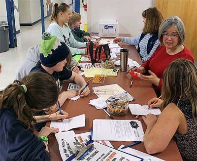 Members of the Langley Middle School Parent Teacher Student Association assist students in writing thank you notes for teachers during lunch Monday morning.