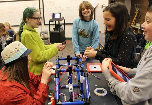 Students work on a robot during Wednesday’s Robotics Anonymous class at South Whidbey Academy.