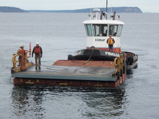 A crew moves the apron back to the transfer span for mounting at the Mukilteo Ferry Terminal last week.
