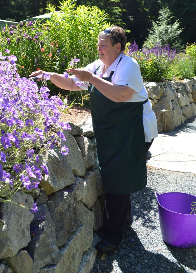 Gloria Sherman clears out areas of her one-acre garden at One Spirit Garden.
