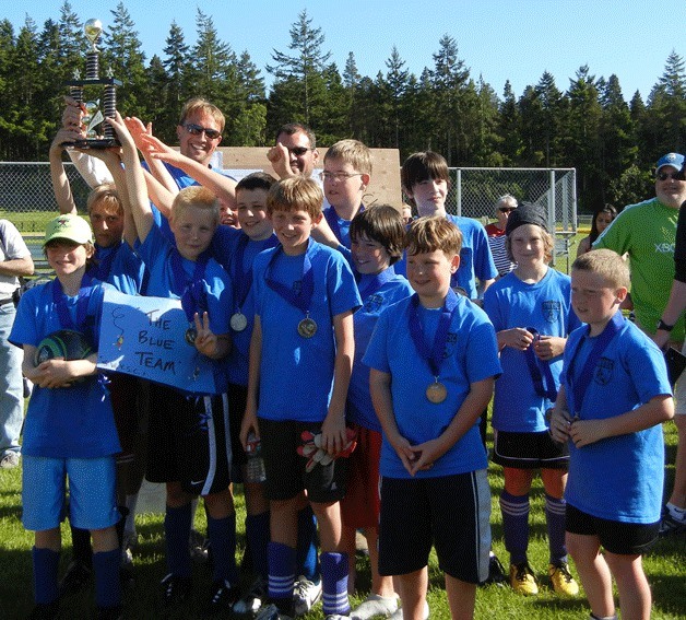 The South Whidbey boys soccer Blue Team holds their Soccerfest trophy. Front row: Ari Rohan