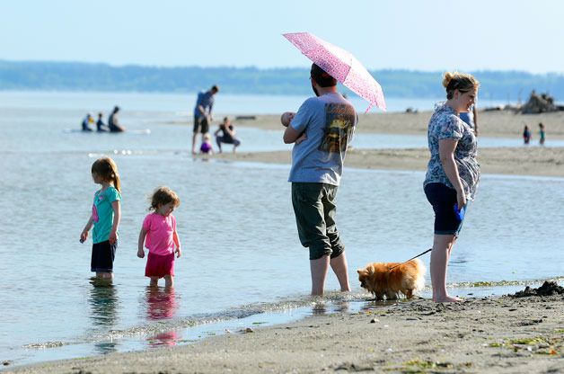 Warm temperatures and sunny skies brought the crowds to Double Bluff Beach Park on Monday. People walked dogs