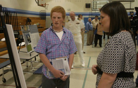 Max Corell of Freeland is tutored on the SBX by Leah Garton of the Missile Defense Agency at Thursday's community meeting in Langley.