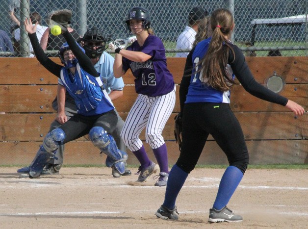 South Whidbey junior catcher Anne Madsen jumps to stop a high pitch by freshman Kacie Hanson in the first round of the 1A District 1 softball tournament May 16.