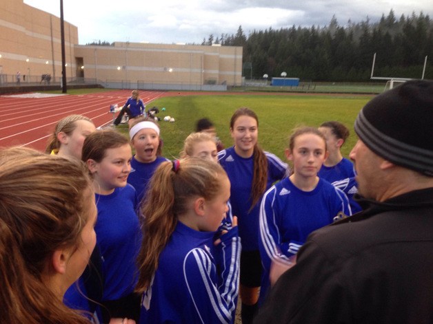 The Langley Middle School girls soccer varsity team listens to coach Erik Jokinen before taking on Sultan in the season finale last week.