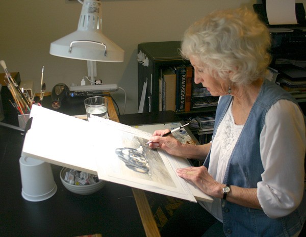 Kate Daniel / The Record Ginny O’Neill works on one of her watercolor paintings