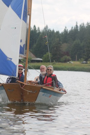 Smiling dinghy sailors enjoy themselves in a well-kept craft. A South Whidbey Yacht Club event at Lone Lake this weekend is open to all