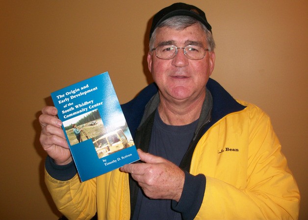 Tim Scriven displays a copy of his new book