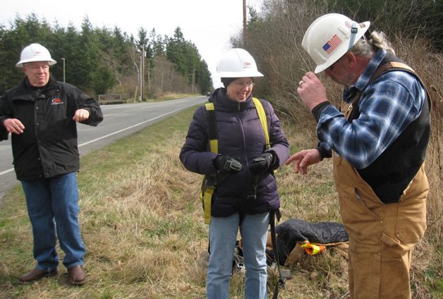 Whidbey Audubon Society Program Chair Robin Llewellyn straps on a safety vest before going up in a “cherry picker” to see an osprey nest earlier this year.