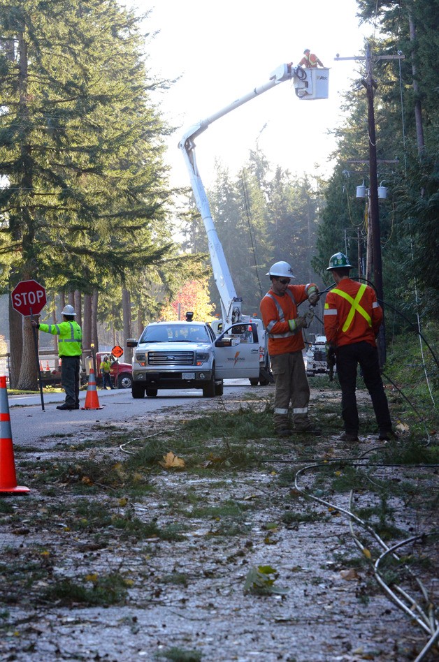 Crews clear the road and power lines of tree debris after the Nov. 17 wind storm knocked down lines and limbs on Maxwelton Road near South Whidbey High School. Another storm is on its way