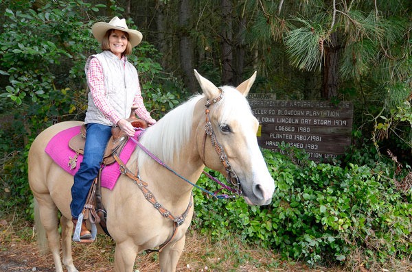 Diana Putney poses near the trailhead of Putney Woods. Putney is the founder of a 4-H group