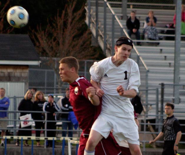 South Whidbey junior mid Darby Hayes collides with Cedarcrest’s senior defender and co-captain Chris Dowd on Monday as he goes for the loose header.