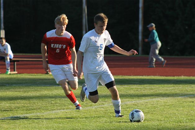 South Whidbey senior Lochlan Roberts dribbles the ball during the Falcons’ match against King’s Wednesday night at Waterman’s Field. The Falcons lost 3-0 and squandered an opportunity to secure a berth to the class 1A state championships.