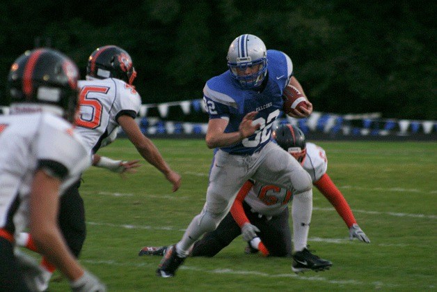 Pat Monell shakes Tigers lineman Zach Whittaker (61) and moves to stiff-arm linebacker Moses Sun (45) on Friday night.