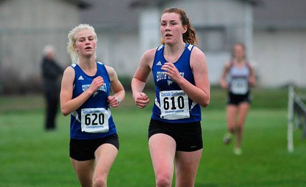 South Whidbey’s Mallorie Mitchem and Elizabeth Donnelly run side-by-side at the Cascade Conference Cross Country Championships on Oct. 24 at Lakewood High School.