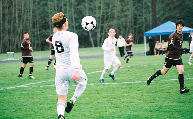 South Whidbey’s Sam Turpin bounces the ball off his chest as Lakewood players wonder what he’ll do next. Also anticipating the action is South Whidbey’s Connor McCauley (17). After falling behind 0-1