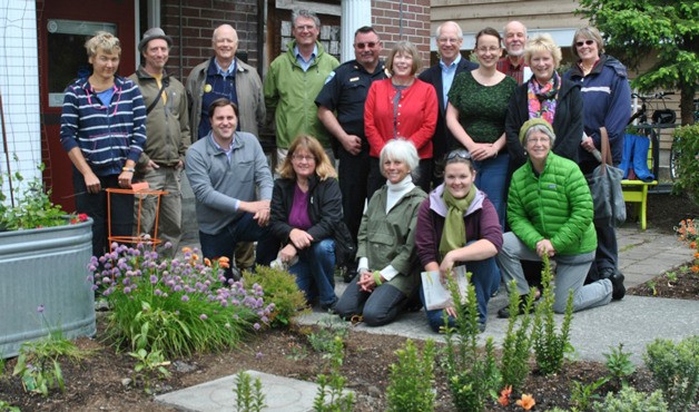 Volunteers and supporters gather for the dedication ceremony of the edible garden in May 2013. In the photo’s front row are: Jeff Arango